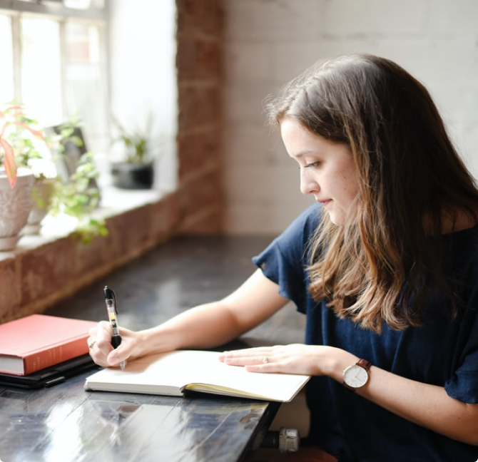 A woman writes in a journal