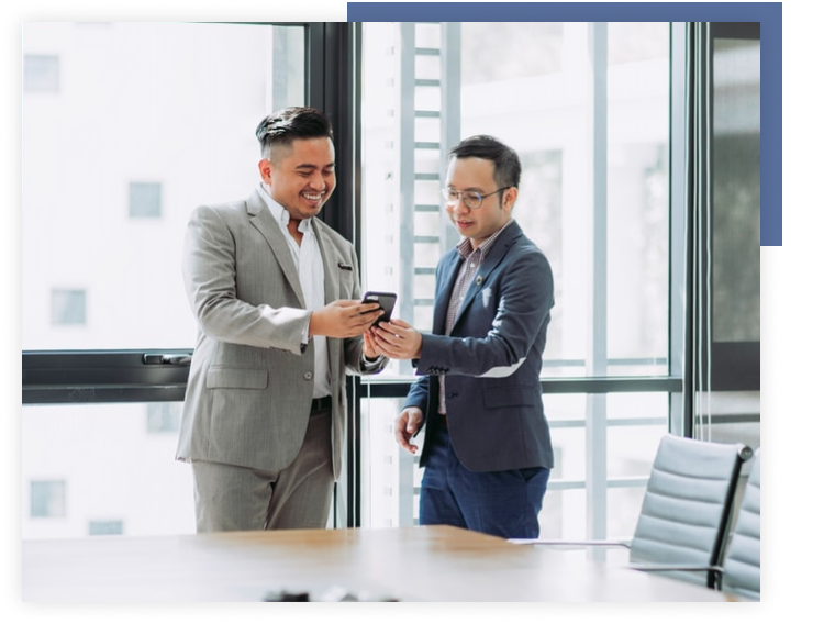 Coworkers looking at a mobile phone screen